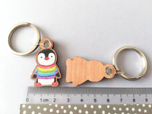 Load image into Gallery viewer, Rainbow penguin keyring, penguin rainbow jumper wooden key fob, ethically sourced wood, small penguin key chain, bag charm
