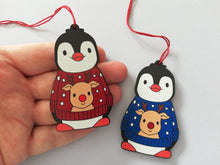 Load image into Gallery viewer, Penguin reindeer jumper decoration. Little wooden penguin wearing a blue or red jumper Christmas ornament, responsibly resourced wood
