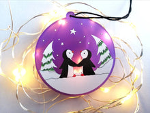 Load image into Gallery viewer, Penguin Christmas tree decoration. Frosted purple acrylic, penguins in the snow, tree Christmas ornament