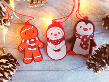 Load image into Gallery viewer, Penguin Christmas decorations. Set of three, frosted red acrylic penguin, snowman and gingerbread man. Cute Christmas tree ornaments.