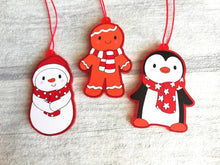 Load image into Gallery viewer, Penguin Christmas decorations. Set of three, frosted red acrylic penguin, snowman and gingerbread man. Cute Christmas tree ornaments.