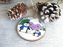 Load image into Gallery viewer, Penguin Christmas decoration. Snowy purple mountains small wooden ornament. Ethically sourced wood. Cute penguins Christmas tree ornaments.