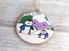 Load image into Gallery viewer, Penguin Christmas decoration. Snowy purple mountains small wooden ornament. Ethically sourced wood. Cute penguins Christmas tree ornaments.