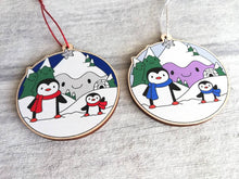 Load image into Gallery viewer, Penguin Christmas decoration. Snowy purple mountains small wooden ornament. Ethically sourced wood. Cute penguins Christmas tree ornaments.