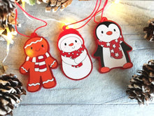 Load image into Gallery viewer, Penguin Christmas decorations. Set of three, frosted red acrylic penguin, snowman and gingerbread man. Cute Christmas tree ornaments.