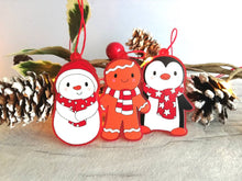 Load image into Gallery viewer, Penguin Christmas decorations. Set of three, frosted red acrylic penguin, snowman and gingerbread man. Cute Christmas tree ornaments.