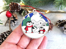 Load image into Gallery viewer, Penguin Christmas decoration. Snowy mountains small wooden ornament. Ethically sourced wood. Cute penguins Christmas tree ornaments.