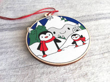 Load image into Gallery viewer, Penguin Christmas decoration. Snowy mountains small wooden ornament. Ethically sourced wood. Cute penguins Christmas tree ornaments.
