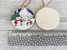 Load image into Gallery viewer, Penguin Christmas decoration. Snowy mountains small wooden ornament. Ethically sourced wood. Cute penguins Christmas tree ornaments.