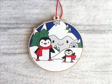 Load image into Gallery viewer, Penguin Christmas decoration. Snowy mountains small wooden ornament. Ethically sourced wood. Cute penguins Christmas tree ornaments.