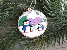 Load image into Gallery viewer, Penguin Christmas decoration. Snowy purple mountains small wooden ornament. Ethically sourced wood. Cute penguins Christmas tree ornaments.