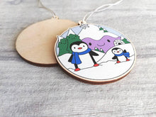 Load image into Gallery viewer, Penguin Christmas decoration. Snowy purple mountains small wooden ornament. Ethically sourced wood. Cute penguins Christmas tree ornaments.