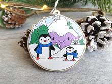 Load image into Gallery viewer, Penguin Christmas decoration. Snowy purple mountains small wooden ornament. Ethically sourced wood. Cute penguins Christmas tree ornaments.
