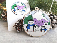 Load image into Gallery viewer, Penguin Christmas decoration. Snowy purple mountains small wooden ornament. Ethically sourced wood. Cute penguins Christmas tree ornaments.