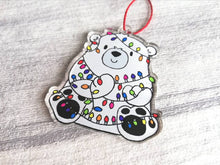 Load image into Gallery viewer, Polar bear Christmas tree decoration. Recycled acrylic Christmas ornament, polar bear tangled up in rainbow coloured fairy lights

