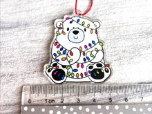 Load image into Gallery viewer, Polar bear Christmas tree decoration. Recycled acrylic Christmas ornament, polar bear tangled up in rainbow coloured fairy lights