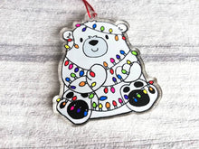 Load image into Gallery viewer, Polar bear Christmas tree decoration. Recycled acrylic Christmas ornament, polar bear tangled up in rainbow coloured fairy lights