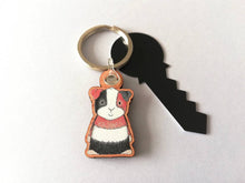 Load image into Gallery viewer, Guinea pig keyring, wooden cavy key fob, tri colour guinea pig key chain, wood bag charm, responsibly resourced wood