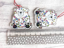 Load image into Gallery viewer, Polar bear Christmas tree decoration. Recycled acrylic Christmas ornament, polar bear tangled up in rainbow coloured fairy lights