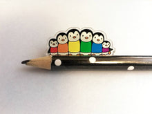 Load image into Gallery viewer, Rainbow penguin pin, recycled acrylic, penguin line up, rainbow jumpers
