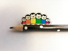 Load image into Gallery viewer, Rainbow penguin pin, recycled acrylic, penguin line up, rainbow jumpers