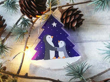 Load image into Gallery viewer, Penguin and star decoration. Eco friendly, purple recycled acrylic Christmas ornament, penguins in the snow