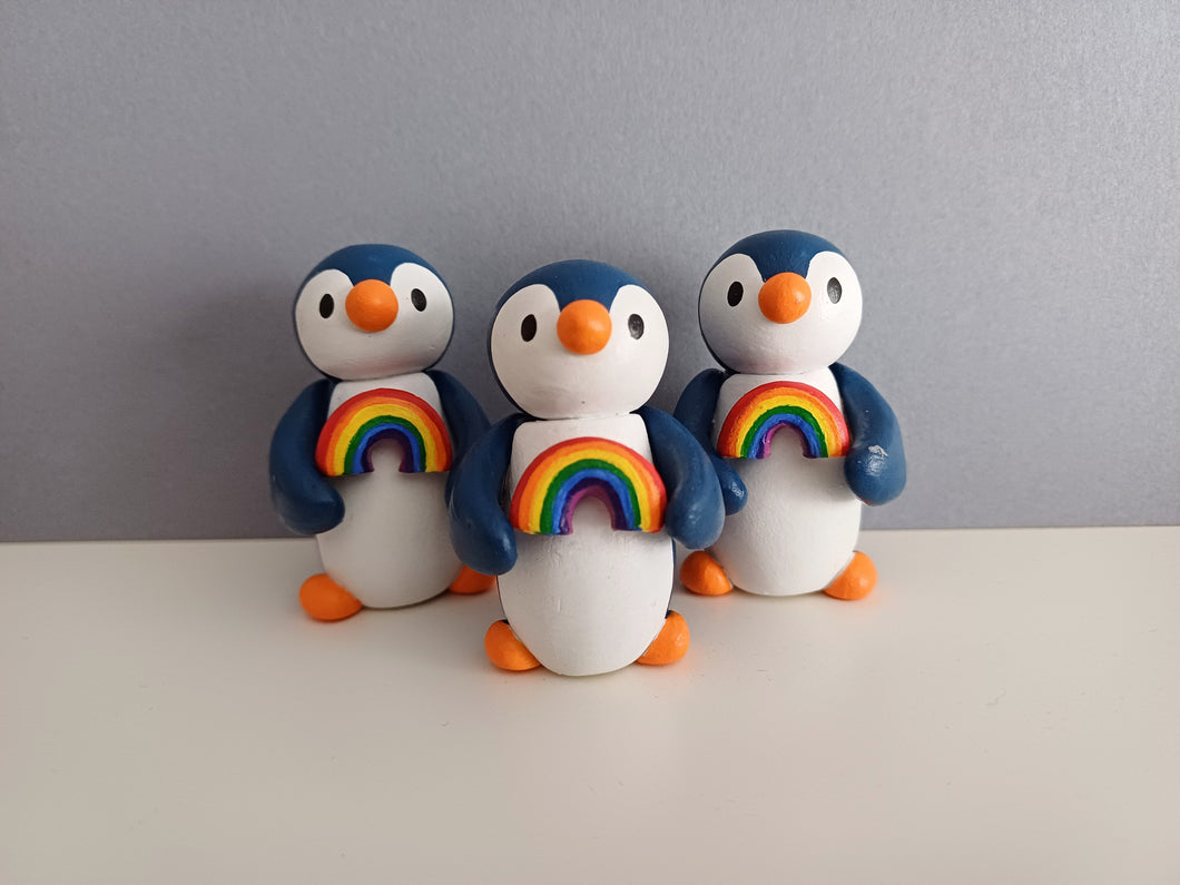 Penguin holding a rainbow