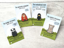 Load image into Gallery viewer, A set of enamel pins. The badger of bravery, the optimistic orangutan, the motivational mole and the resilient rhino

