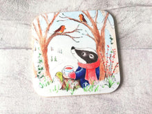 Load image into Gallery viewer, Badger sat under a tree with two robins. Winter countryside design with snowdrops. Square glossy small coaster
