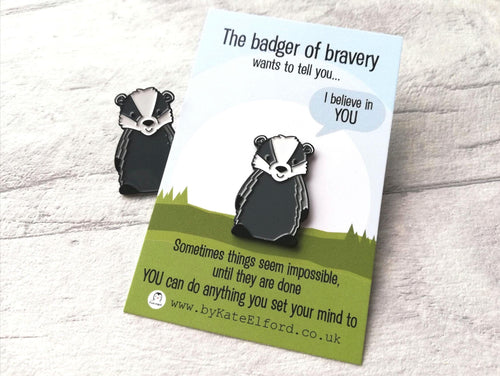 A badger of bravery enamel pin. The backing card has the wording the badger of bravery wants to tell you I believe in you. Sometimes things seem impossible until they are done. You can do anything you set your mind to