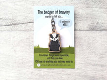 Load image into Gallery viewer, Miniature badger wood keyring. The backing card has the wording the badger of bravery wants to tell you I believe in you. Sometimes things seem impossible until they are done. You can do anything you set your mind to
