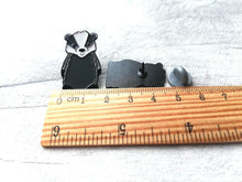 Load image into Gallery viewer, A badger enamel pin next to a ruler as a size guide
