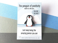 Load image into Gallery viewer, A little penguin enamel pin on a blue and white snow scene backing card with the wording the penguin of positivity wants to tell you, you are the best. Just keep being the amazing person you are
