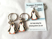Load image into Gallery viewer, A little wooden penguin keyring on a backing card with the wording the penguin of positivity wants to tell you, you are the best. Just keep being the amazing person you are. There are two more matching penguin keyrings in the picture
