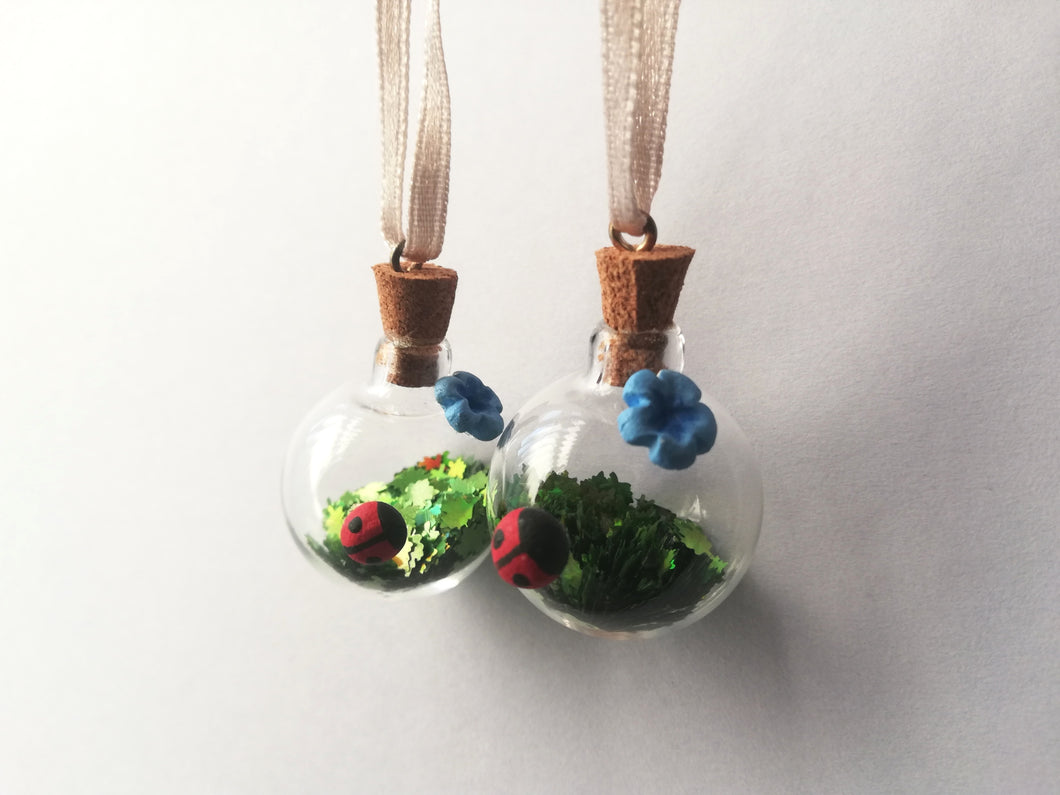 Tiny pottery ladybird and glass bauble