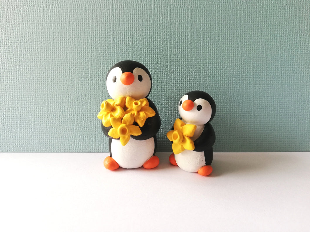 Pair of penguins and daffodils
