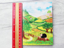Load image into Gallery viewer, A mole A6 notebook next to a ruler as a size guide
