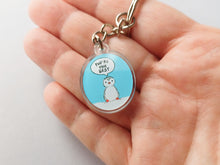 Load image into Gallery viewer, Mini oval recycled acrylic keyring. The design is a little penguin on a light blue background with a speech bubble saying you're the best. It is shown in a hand to show how small it is
