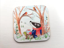 Load image into Gallery viewer, Badger sat under a tree with two robins. Winter countryside design with snowdrops. Square glossy small coaster
