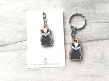 Load image into Gallery viewer, Little badger keyring, made from wood, on a grey and white polka dot backing card
