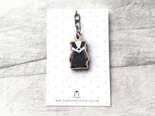 Load image into Gallery viewer, A mini wood badger keyring on a, grey and white polka dot backing card

