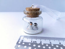 Load image into Gallery viewer, Miniature penguin Christmas decoration. Little pottery penguins and chick in a glass bottle. Christmas penguin mini ornament, mothers day
