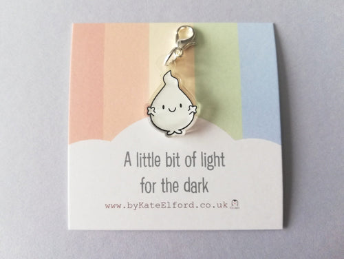 A little bit of light for the dark. I little white flame shape character with out stretched arms and a happy fave. It is made from recycled acrylic and has a clip so it can be used as a stitch marker or a charm