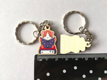 Load image into Gallery viewer, Mini guinea pig reading a book keyring, small wooden key fob, ethically sourced wood, guinea pig and books key chain, bag charm
