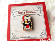 Load image into Gallery viewer, Christmas penguin wooden pin brooch, Cute little penguin badge, holding a Christmas stocking, eco friendly wood
