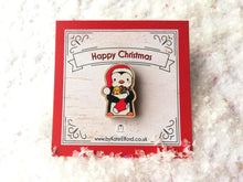 Load image into Gallery viewer, Christmas penguin wooden pin brooch, Cute little penguin badge, holding a Christmas stocking, eco friendly wood
