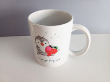 Load image into Gallery viewer, White ceramic mug with a penguin holding a strawberry and has the wording I love you berry much 

