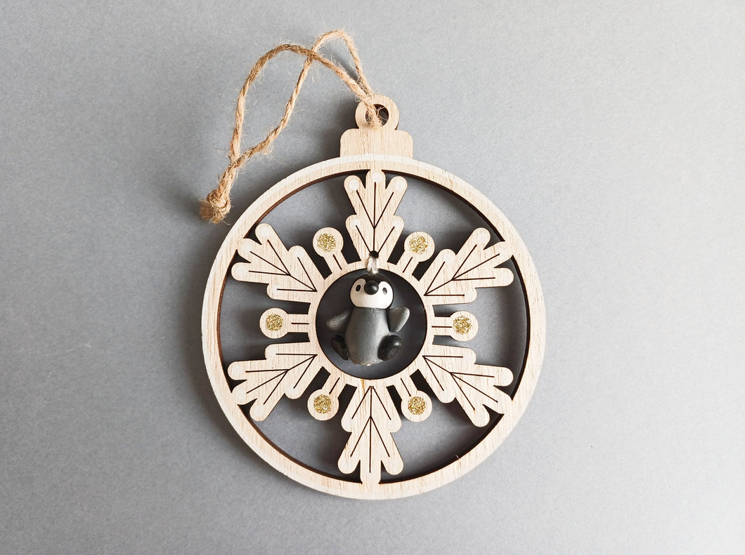 Wooden snowflake and penguin