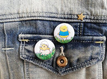 Load image into Gallery viewer, Cute yellow Easter chick button badges. One in a blue jumper, one hatching from an egg
