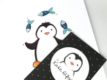 Load image into Gallery viewer, Circus penguin print, black and white penguin juggling three blue fish
